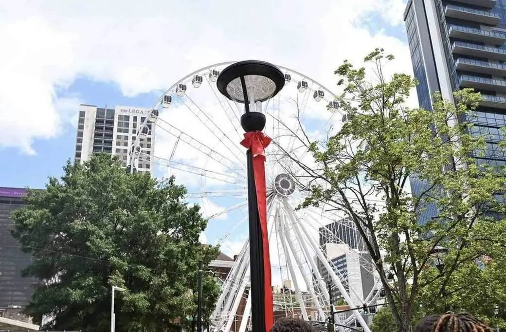 A new SMART City streetlight unveiled with a red ribbon near the SkyView wheel at Centennial Olympic Park