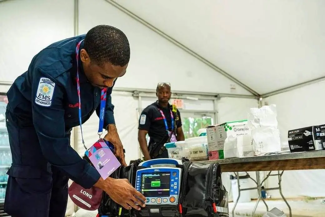 An AFRD EMS medic checks a defibrillator in the Fan Festival field hospital