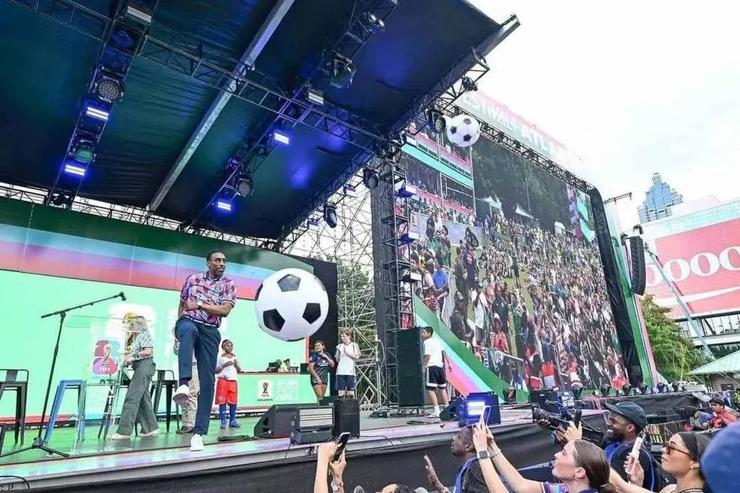 Mayor Dickens juggling a soccer ball on stage at the FIFA Fan Festival